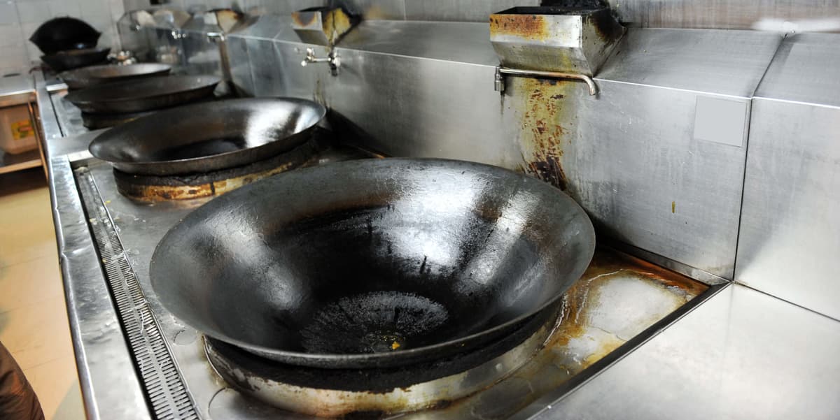 Professional commercial kitchen cleaning showing grease trap and exhaust system maintenance Denver